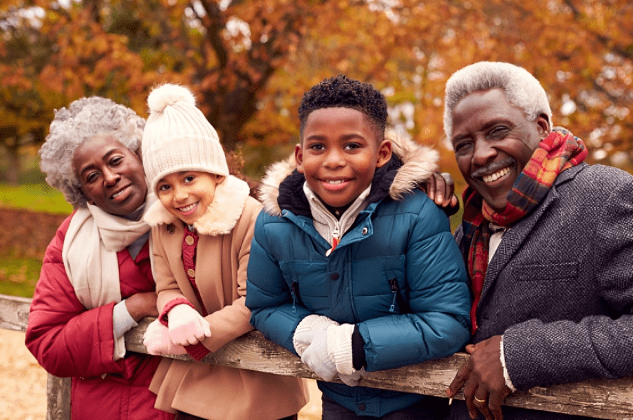 Happy multigenerational family enjoying autumn outdoors.